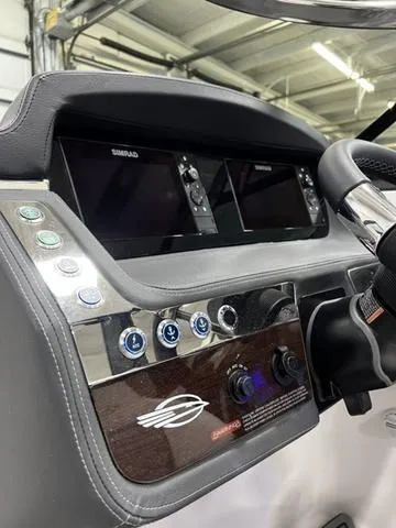 Slide: The Image of 2024 Chaparral 287 SSX boat dashboard with dual Simrad displays and control buttons. - 24