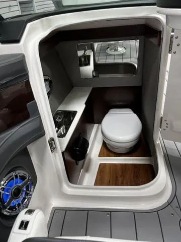 Slide: The Image of 2024 Chaparral 287 SSX boat interior bathroom with modern amenities. - 29