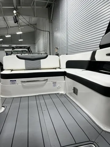 Slide: The Image of 2024 Chaparral 287 SSX boat interior with white and black seating. - 32