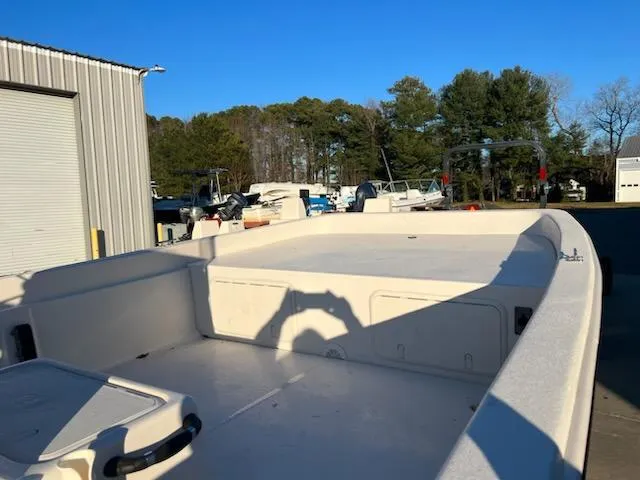 Slide: The Image of 2025 Carolina Skiff E21 DLX CC boat deck in a marina setting. - 3