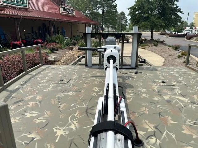 Slide: The Image of 2024 Tracker Grizzly 2072 CC Sportsman boat with camo deck and mounted equipment. - 3