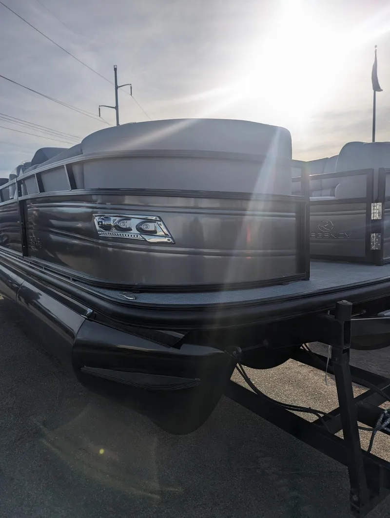 The Image of 2024 Regency 230 LE3 pontoon boat in sunlight, showcasing sleek design and modern features. - 0