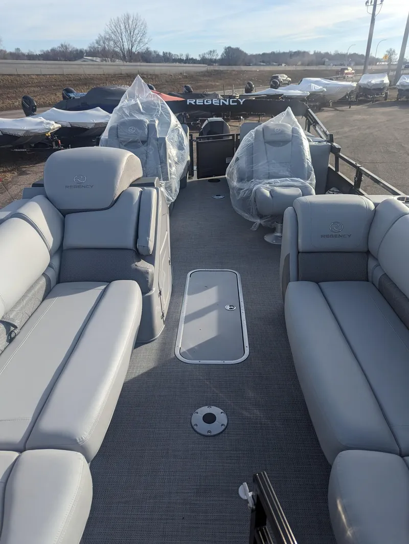 Slide: The Image of 2024 Regency 230 LE3 pontoon boat with spacious seating and modern design. - 10