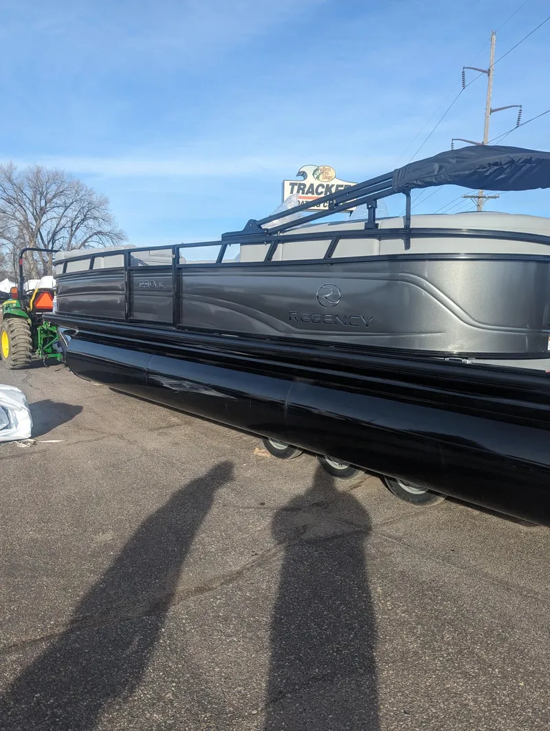 Slide: The Image of 2024 Regency 230 LE3 pontoon boat displayed outdoors on a sunny day. - 3
