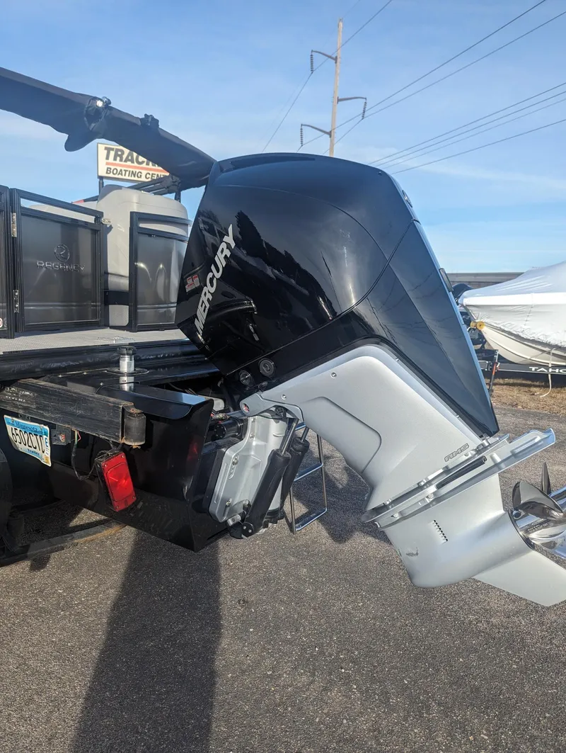 Slide: The Image of 2024 Regency 230 LE3 boat with Mercury outboard motor on trailer. - 5