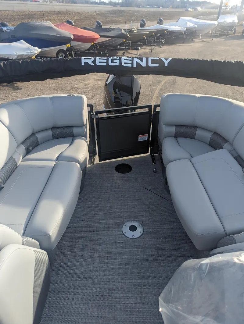 Slide: The Image of 2024 Regency 230 LE3 pontoon boat with spacious seating and modern design. - 9