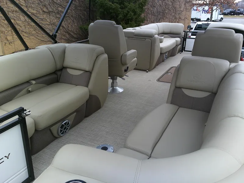 Slide: The Image of 2024 Regency 230 DL3 pontoon boat with luxurious beige seating and spacious layout. - 3