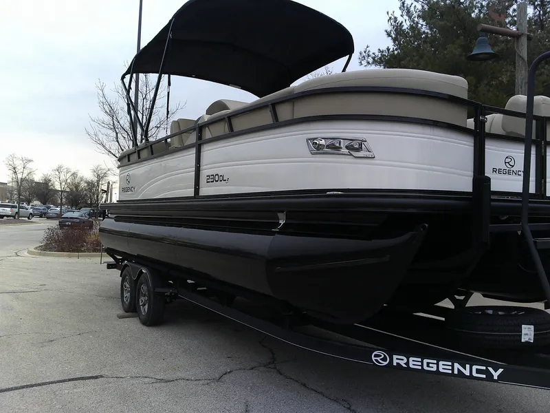 Slide: The Image of 2024 Regency 230 DL3 pontoon boat on a trailer. - 6