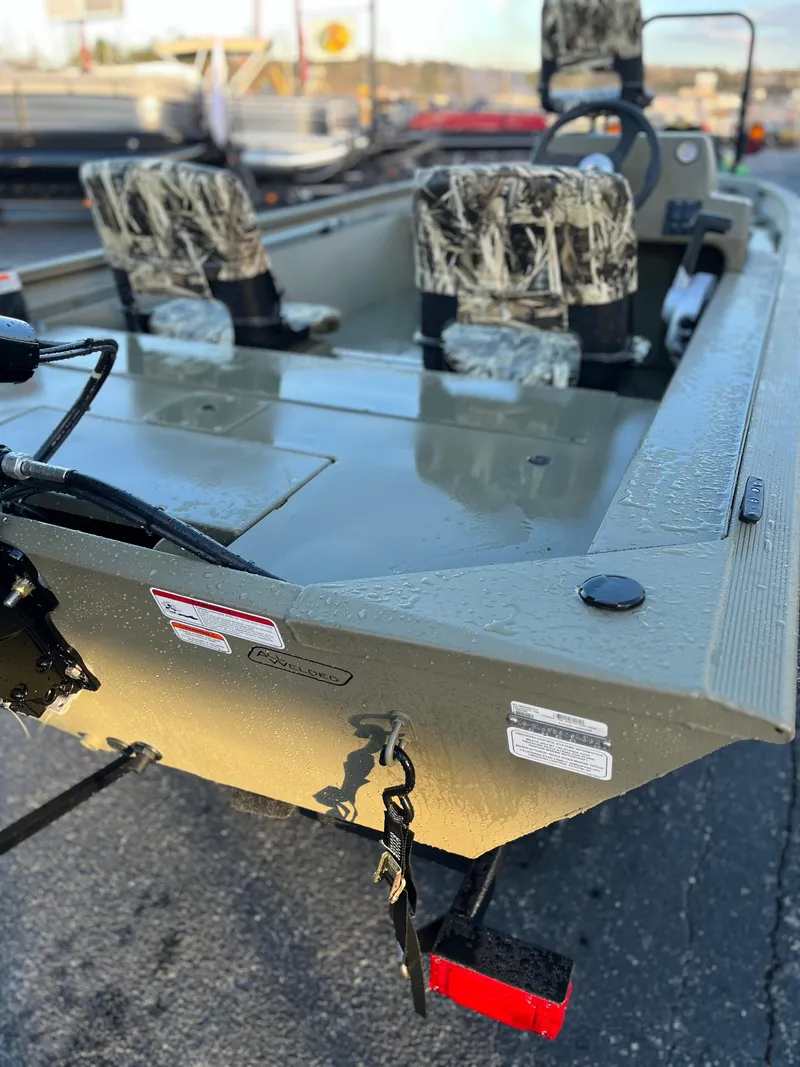 Slide: The Image of 2024 Tracker Grizzly 1754 SC boat with camouflage seats, rear view. - 3