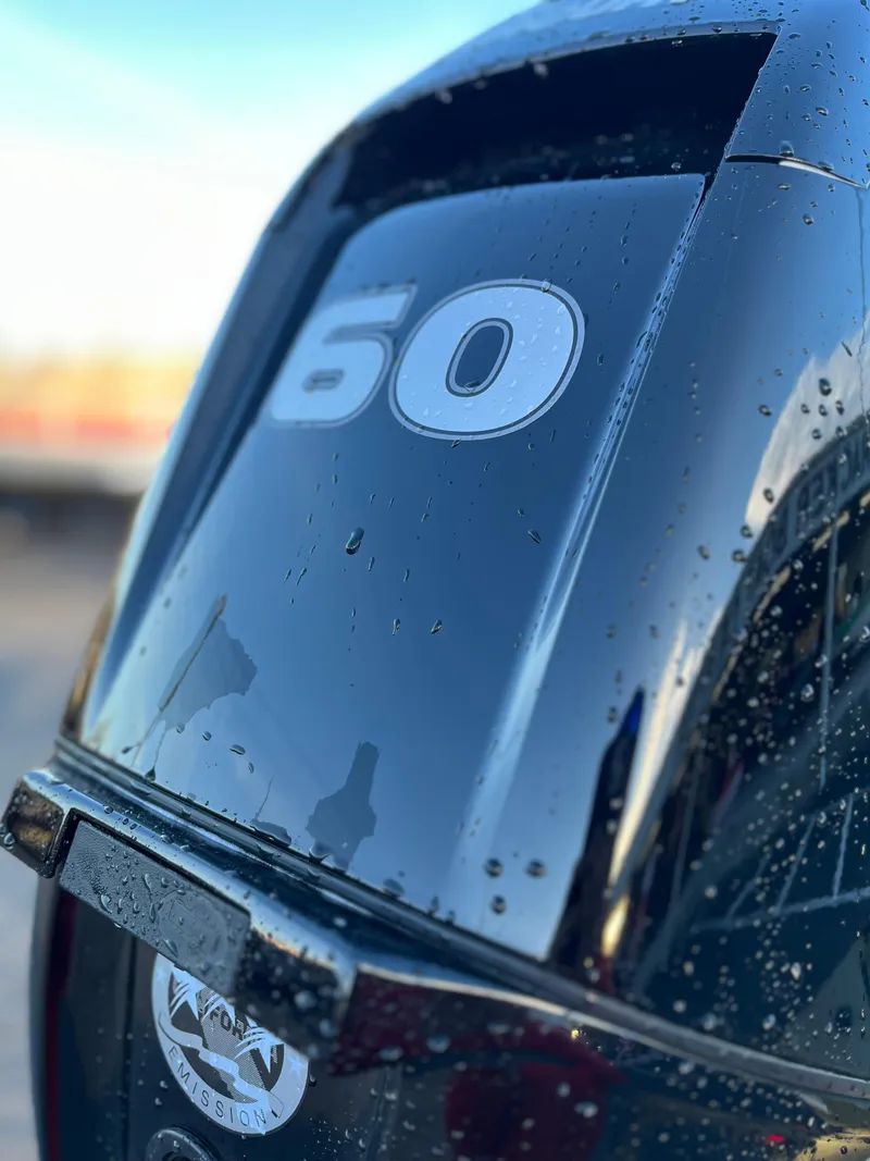 Slide: The Image of Close-up of 2024 Tracker Grizzly 1754 SC outboard motor with water droplets. - 4