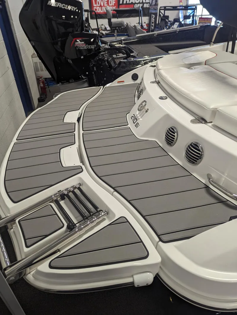 Slide: The Image of 2024 Tahoe 210 Si boat with sleek gray deck and ladder. - 7