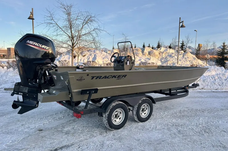 The Image of 2024 Tracker Grizzly 2072 CC boat with Mercury engine on snowy landscape. - 0