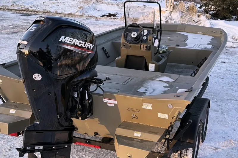 Slide: The Image of 2024 Tracker Grizzly 2072 CC boat with Mercury engine in snow. - 10