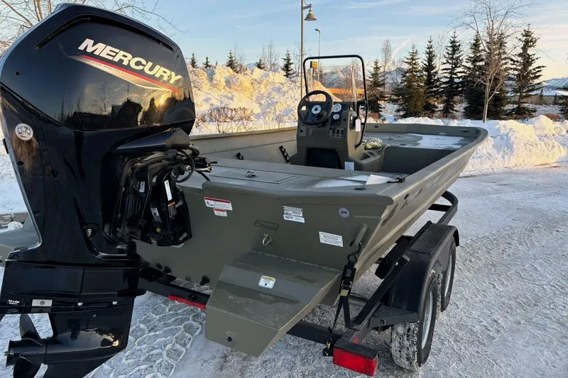 Slide: The Image of 2024 Tracker Grizzly 2072 CC boat with Mercury engine, parked on snowy ground. - 11