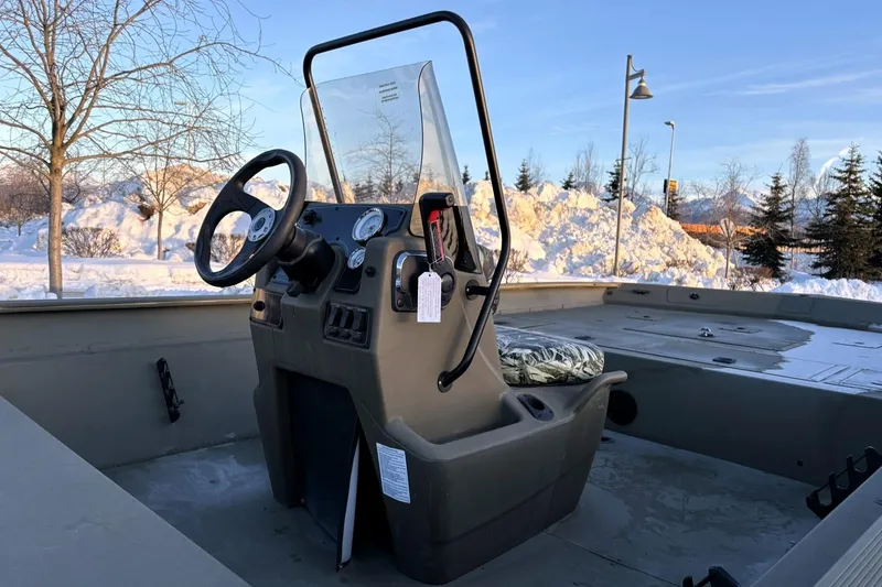 Slide: The Image of 2024 Tracker Grizzly 2072 CC boat console in snowy outdoor setting. - 12
