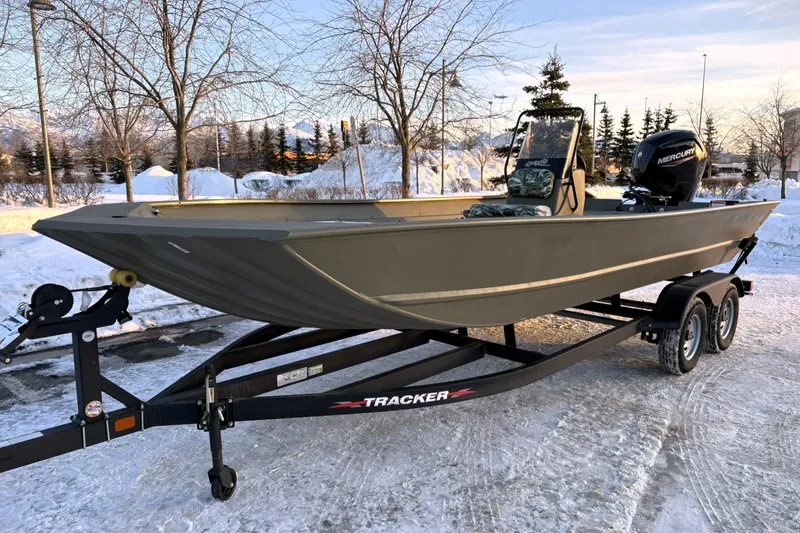 Slide: The Image of 2024 Tracker Grizzly 2072 CC boat on trailer in snowy landscape. - 4