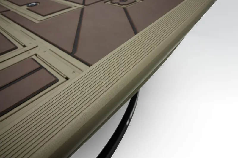 Slide: The Image of 2024 Tracker Grizzly 2072 CC boat deck with textured surface and sleek design. - 46