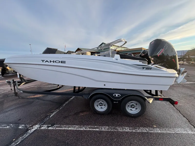 The Image of 2024 Tahoe T21 boat on trailer in parking lot, side view. - 0