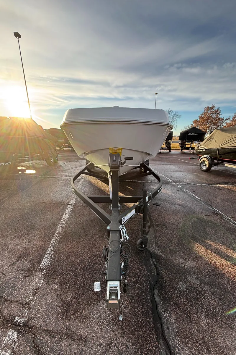 Slide: The Image of 2024 Tahoe T21 boat on trailer in parking lot at sunset. - 10