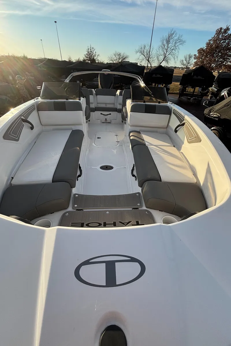 Slide: The Image of 2024 Tahoe T21 boat interior with gray seating, open deck, and sunny background. - 12