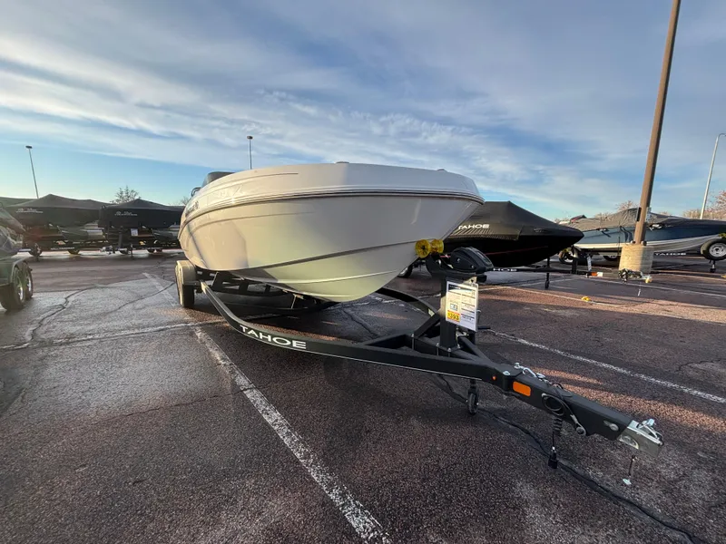 Slide: The Image of 2024 Tahoe T21 boat on trailer in parking lot under cloudy sky. - 3