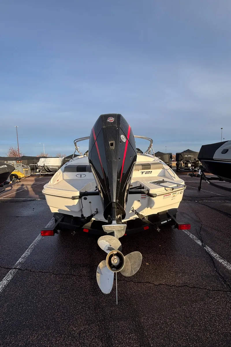 Slide: The Image of 2024 Tahoe T21 boat with outboard motor in a parking lot. - 6