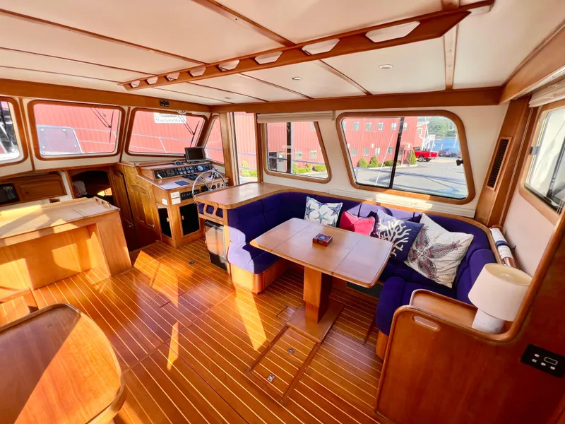 Slide: The Image of Interior of 2001 Sabre Sabreline 47 yacht with wooden flooring and cozy seating area. - 13