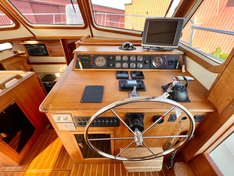 Slide: The Image of 2001 Sabre Sabreline 47 yacht helm station with navigation equipment and wooden finish. - 20