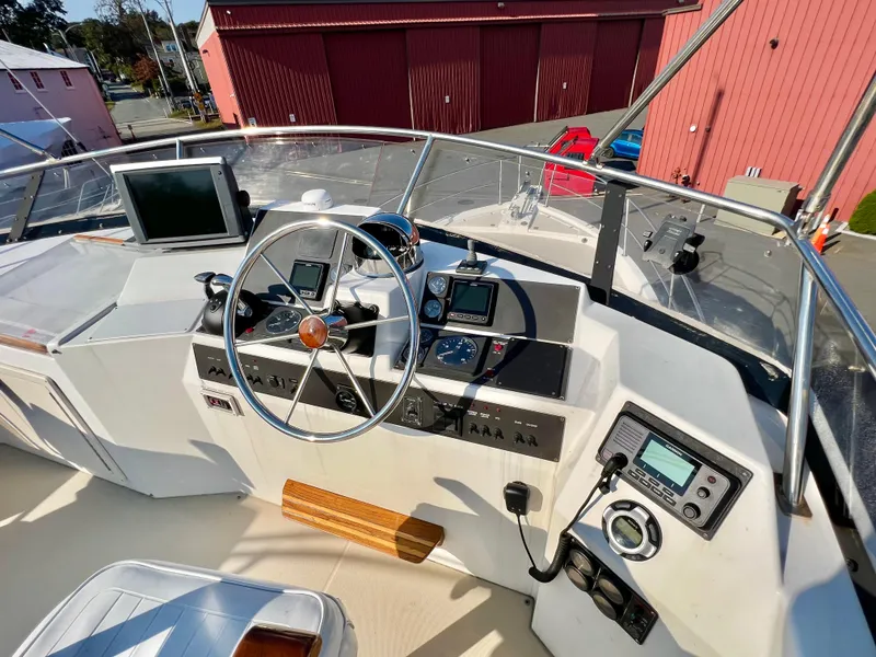 Slide: The Image of 2001 Sabre Sabreline 47 yacht helm station with navigation equipment and steering wheel. - 24