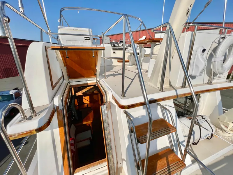 Slide: The Image of 2001 Sabre Sabreline 47 yacht with open cabin entrance and wooden steps. - 25