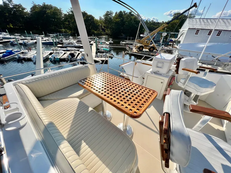 Slide: The Image of Flybridge seating area on a 2001 Sabre Sabreline 47 yacht, overlooking a marina. - 28