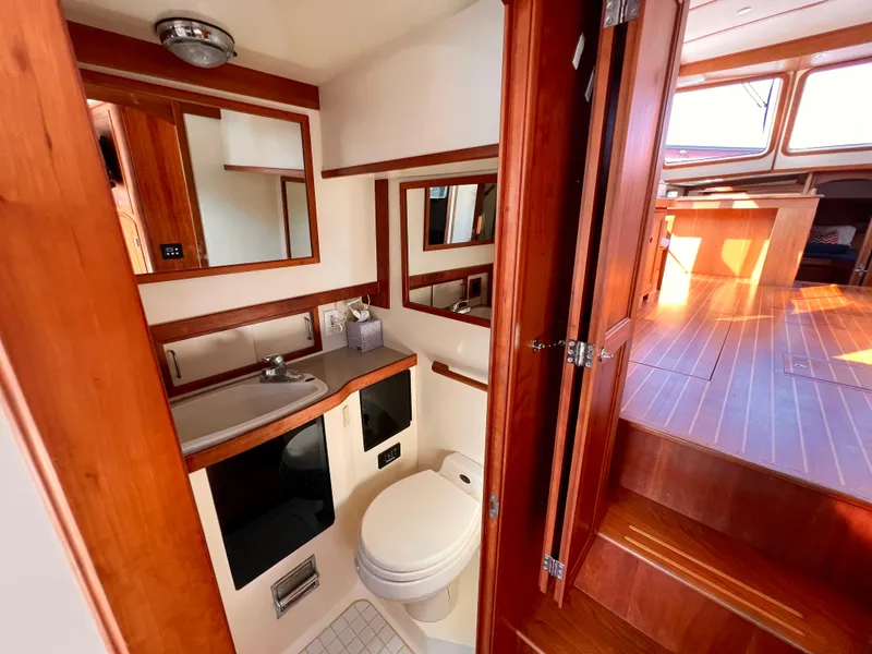 Slide: The Image of 2001 Sabre Sabreline 47 yacht bathroom with wooden cabinetry and modern fixtures. - 5