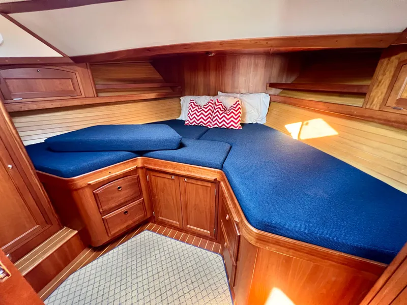 Slide: The Image of Cozy cabin interior of 2001 Sabre Sabreline 47 with blue bedding and wooden cabinetry. - 7