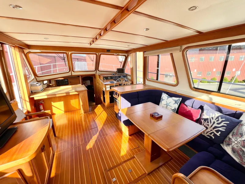 Slide: The Image of Interior of 2001 Sabre Sabreline 47 yacht with wooden flooring and cozy seating area. - 12