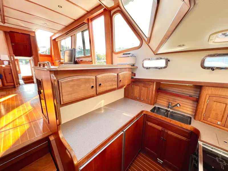 Slide: The Image of Interior of 2001 Sabre Sabreline 47 yacht with wooden cabinetry and ample natural light. - 16