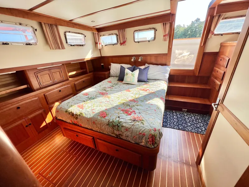 Slide: The Image of Luxurious master cabin in 2001 Sabre Sabreline 47 yacht with wood finish and queen bed. - 2