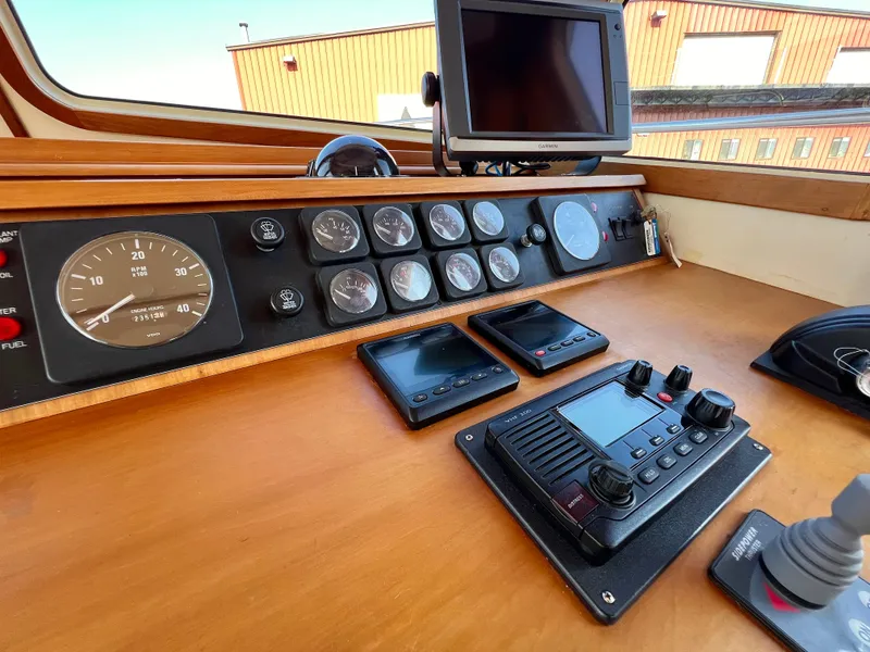 Slide: The Image of 2001 Sabre Sabreline 47 boat helm with gauges, controls, and navigation equipment. - 22