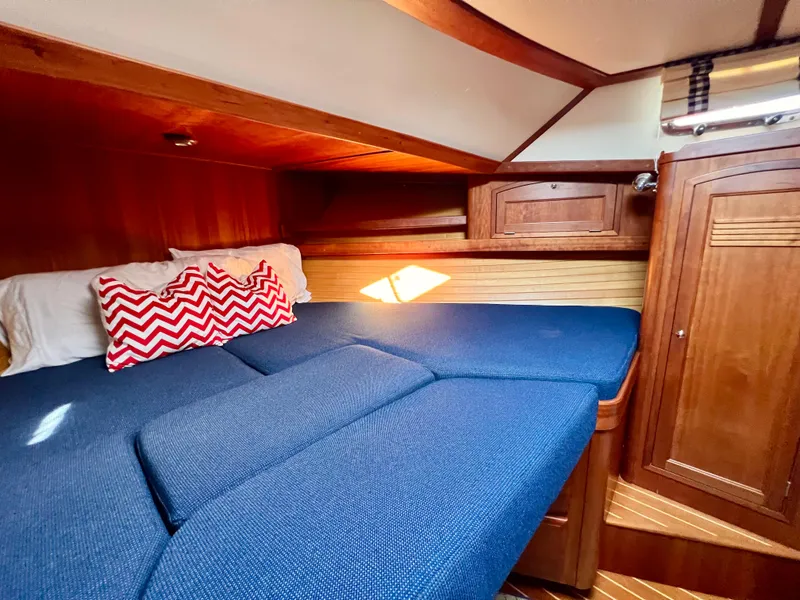 Slide: The Image of Cozy cabin interior of 2001 Sabre Sabreline 47 yacht with blue bedding and wooden accents. - 6