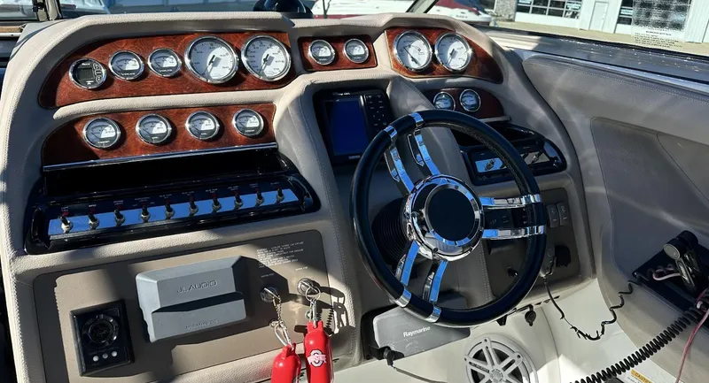 Slide: The Image of 2006 Cobalt 323 boat dashboard with gauges and steering wheel. - 10