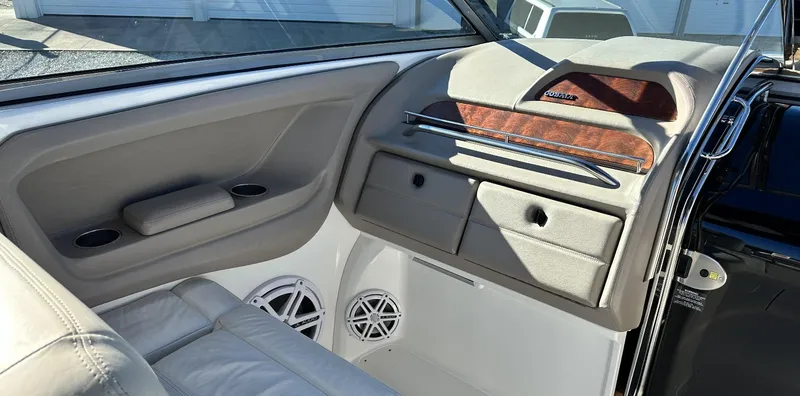 Slide: The Image of Interior of a 2006 Cobalt 323 boat with beige seating and storage compartments. - 11