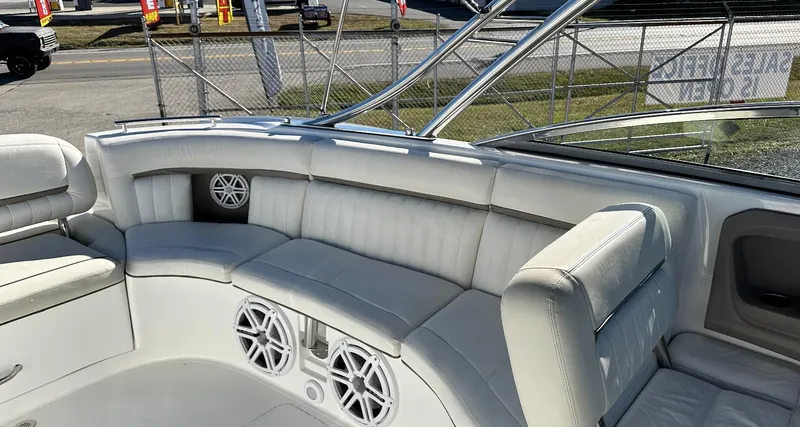 Slide: The Image of 2006 Cobalt 323 boat interior with white leather seating and built-in speakers. - 12