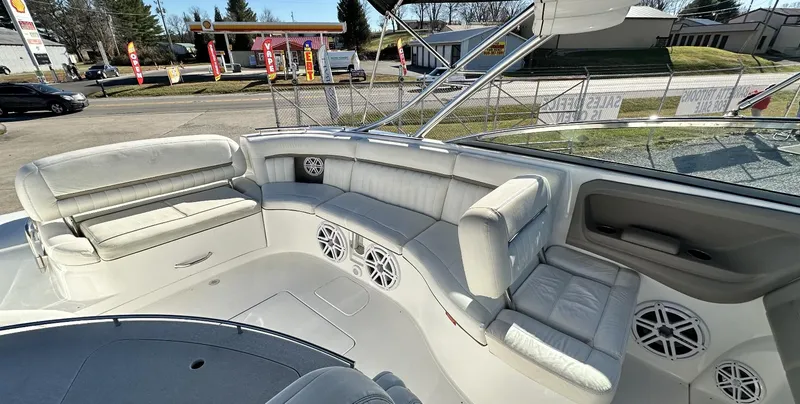 Slide: The Image of 2006 Cobalt 323 boat interior with white leather seating and built-in speakers. - 13