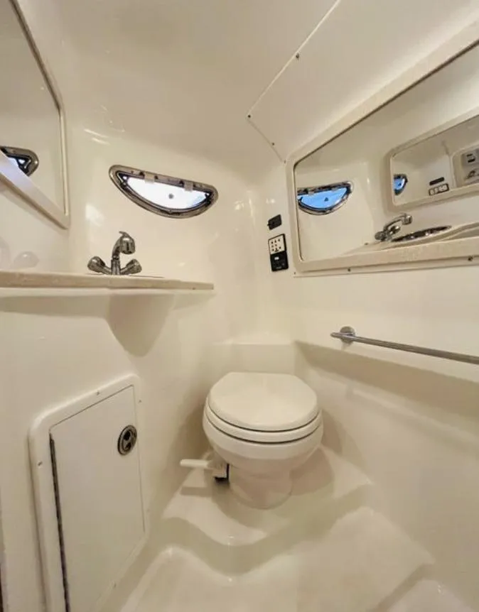 Slide: The Image of Compact bathroom in 2006 Cobalt 323 boat with toilet, sink, and mirror. - 16