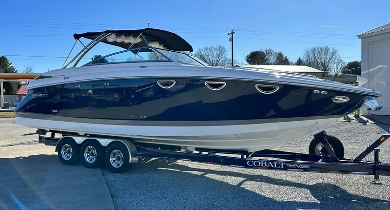 Slide: The Image of 2006 Cobalt 323 boat on a trailer in a parking lot. - 5