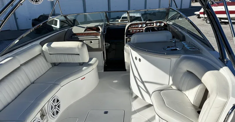 Slide: The Image of 2006 Cobalt 323 boat interior with white leather seating and modern dashboard. - 8