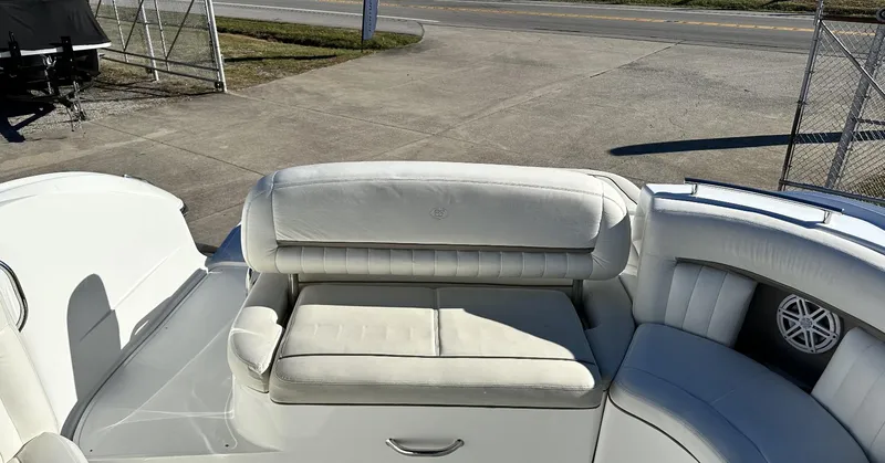 Slide: The Image of 2006 Cobalt 323 boat with white leather seating and speaker on deck. - 9