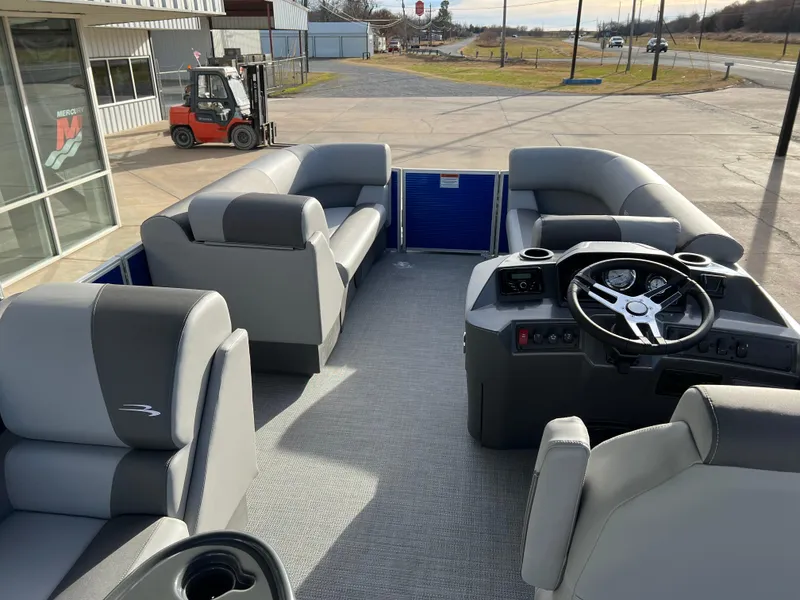 Slide: The Image of 2024 Bennington 188 SVL pontoon boat interior with gray seating and steering console. - 4