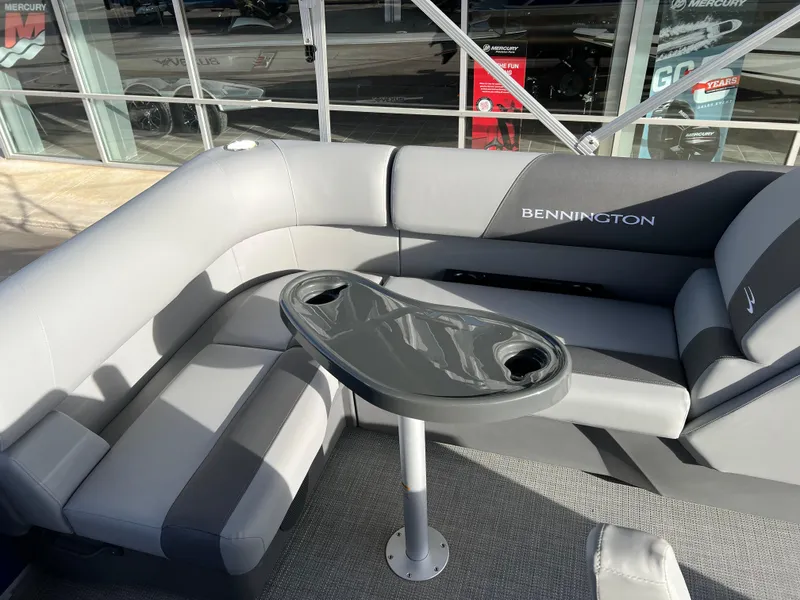 Slide: The Image of 2024 Bennington 188 SVL pontoon boat interior with gray seating and table. - 5