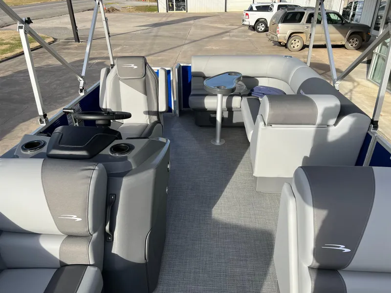 Slide: The Image of 2024 Bennington 188 SVL pontoon boat interior with gray seating and steering console. - 8
