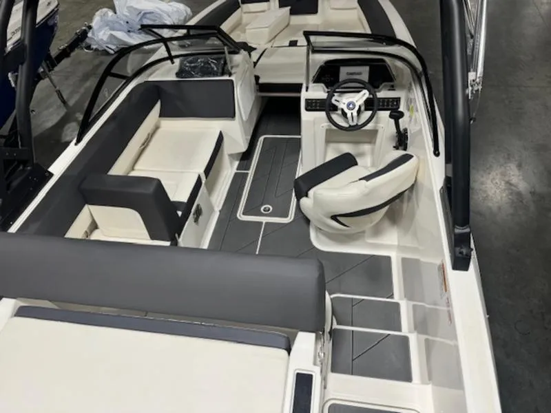 Slide: The Image of 2024 Bayliner DX2000 boat interior with modern seating and steering console. - 8